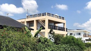 A modern two-story building with balconies, a staircase, and a satellite dish. - Pontoon <ishigakijima> (Ishigaki)