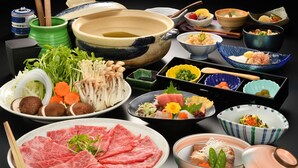 A variety of dishes and bowls on a table, including meat, vegetables, and seafood. - Ashino Onsen Hotel (Nasu)