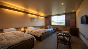 A hotel room with two beds, a desk, a chair, a TV, and a window with a view. - Ashino Onsen Hotel (Nasu)