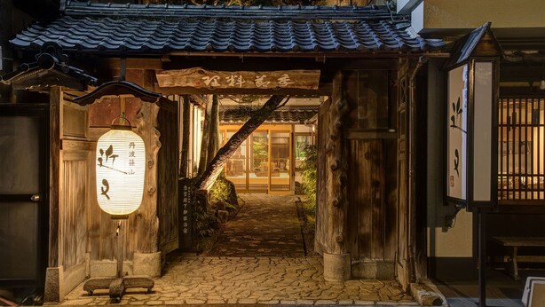 A traditional Japanese building with a wooden entrance, a tiled roof, and a stone pathway leading to the door. - Tanba Sasayama Kinmata (Sasayama)