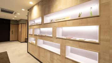 A reception area with wooden paneling and multiple illuminated display shelves.
