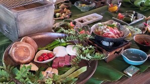 A variety of food items and a grill setup on a table. - Kasamatsutei (Aridagawa)