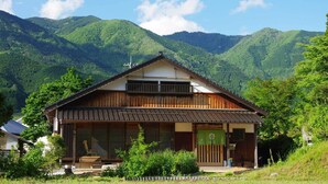 A traditional wooden house with a sloped roof, large windows, and a wooden porch. - Farm Resort Awanowa (Mimasaka)