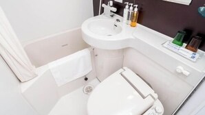 A compact bathroom with a toilet, sink, and shower. - Super Hotel Saitama Kuki (Kuki)