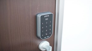 A numeric keypad door lock with a card reader above it. - Condominium Yuyuki (Yomitan)