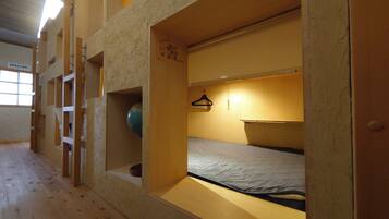 A bunk bed room with a globe and a hanging hanger.