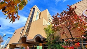 A hotel with a prominent tower, arched entrance, and a brick facade. - Tochigi Grand Hotel (Tochigi)