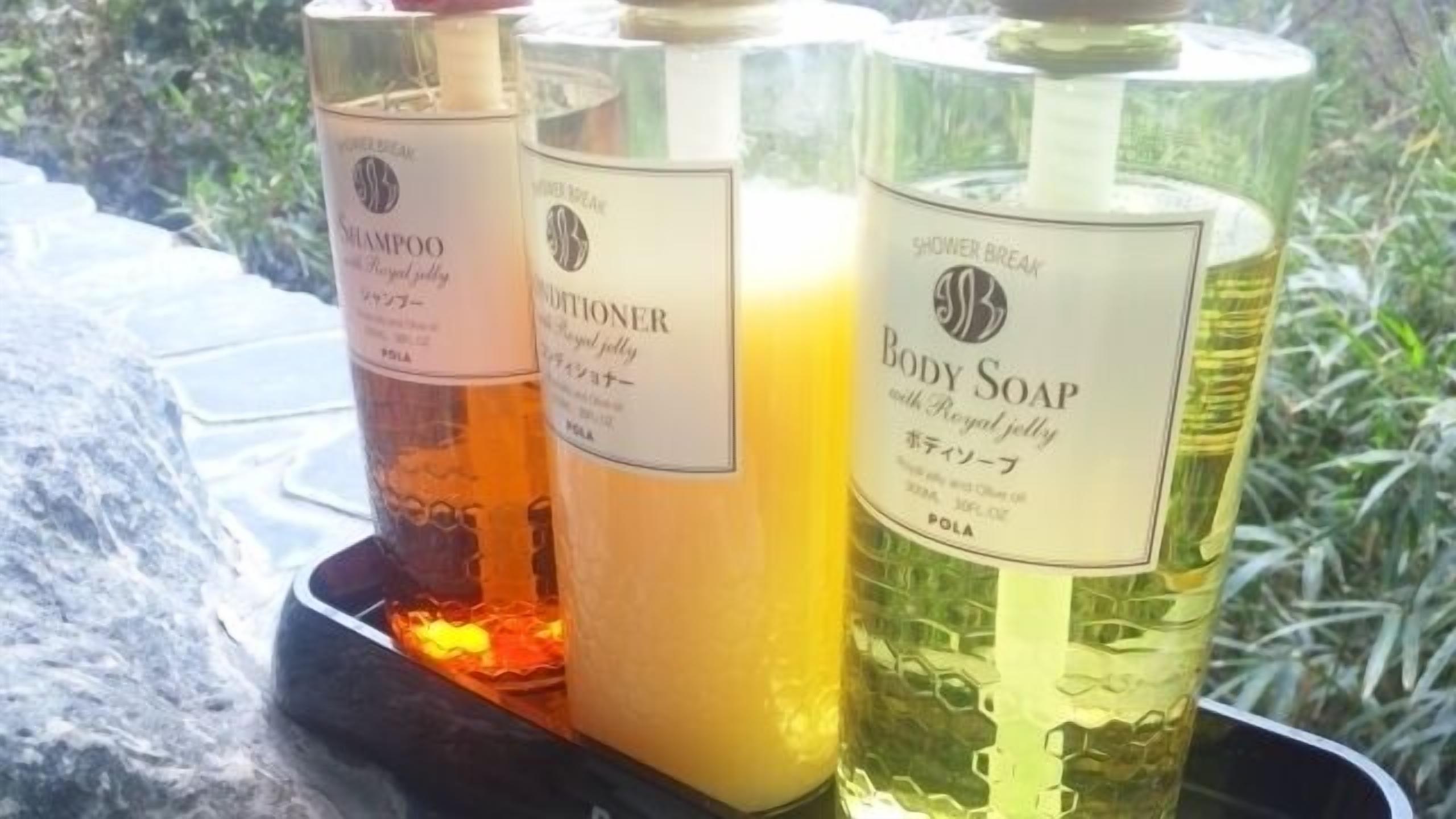 Three bottles of body care products on a tray.