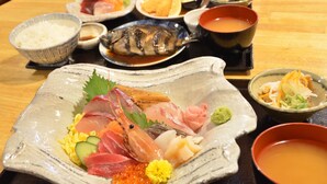 A variety of dishes on a table, including sushi, sashimi, and a bowl of soup. - Kominkano Yado Saika-an (Maizuru)