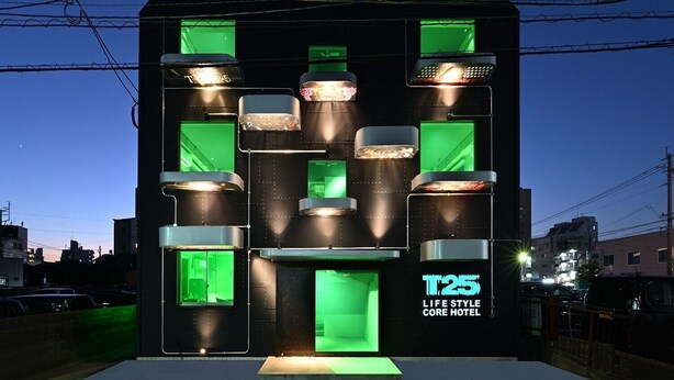 A modern building with multiple illuminated windows and a sign reading "T25 LIFE STYLE CORE HOTEL". - T25 (Miyazaki)