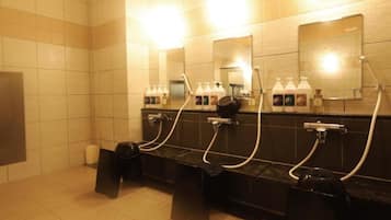 A public restroom with multiple sinks, mirrors, and hand soap dispensers.