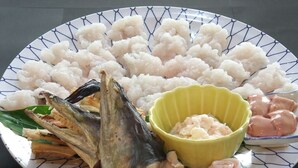 A plate with various seafood items including fish, shrimp, and possibly other seafood. - Pension Mangame (Awaji)