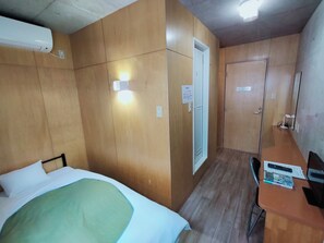 A room with a bed, a desk, a chair, and a door. - Weekly Sho Gifu Hashima Hostel (Hashima)