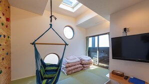 A room with a hanging chair, a bed with pillows, a television, and a window with curtains. - Tomareru Himitsukichi L-base (Matsumoto)