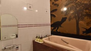 A bathroom with a bathtub, a sink, and a mirror.