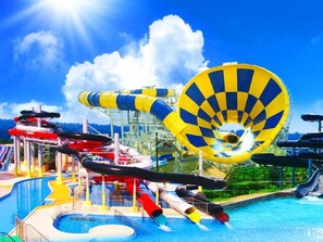 A water park with various water slides and a large pool.