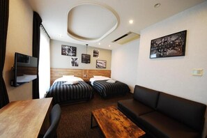 A hotel room with two beds, a sofa, a wooden table, and a TV. - Hotel Cooju Fukui (Sakai)