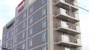 A multi-story hotel with a modern design, featuring balconies on each floor and a prominent signage at the top. - Misawa in Koyo (Misawa)