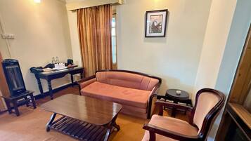Grand Suite | Living area | 10-inch TV with cable channels, first-run films