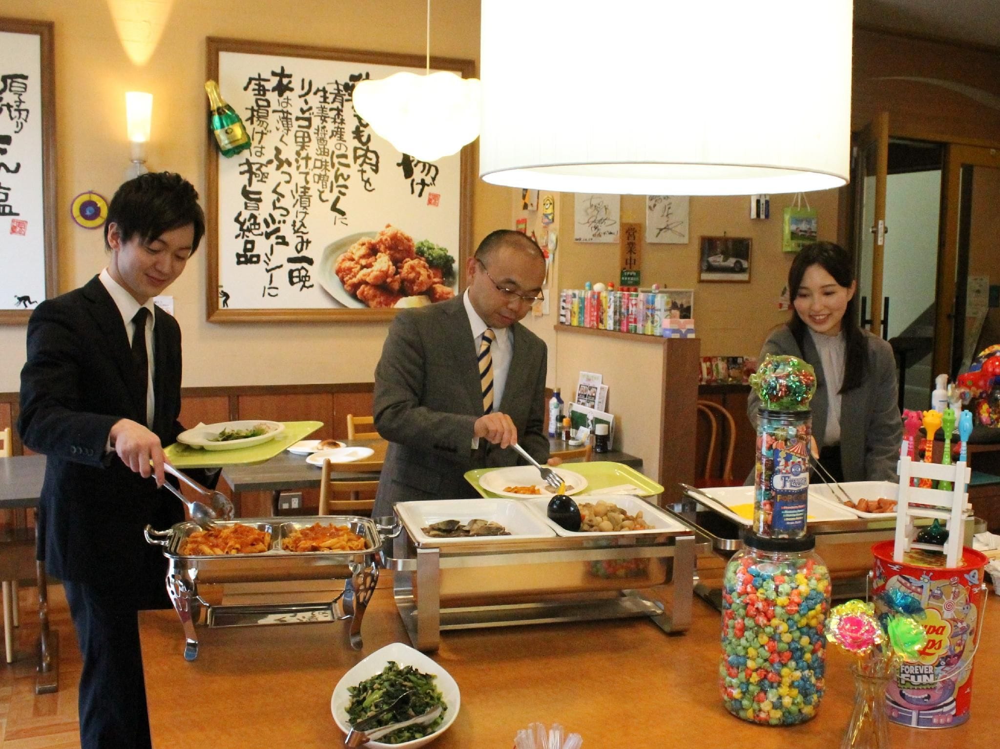 A restaurant with a buffet setup, including various dishes and a candy dispenser.