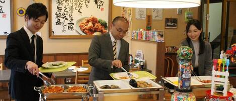 A restaurant with a buffet setup, including various dishes and a candy dispenser.