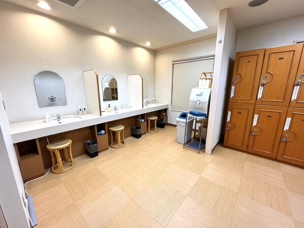 A public restroom with multiple sinks, mirrors, and wooden lockers. - Shizuoka Hotel Tokinosumika (Shizuoka)