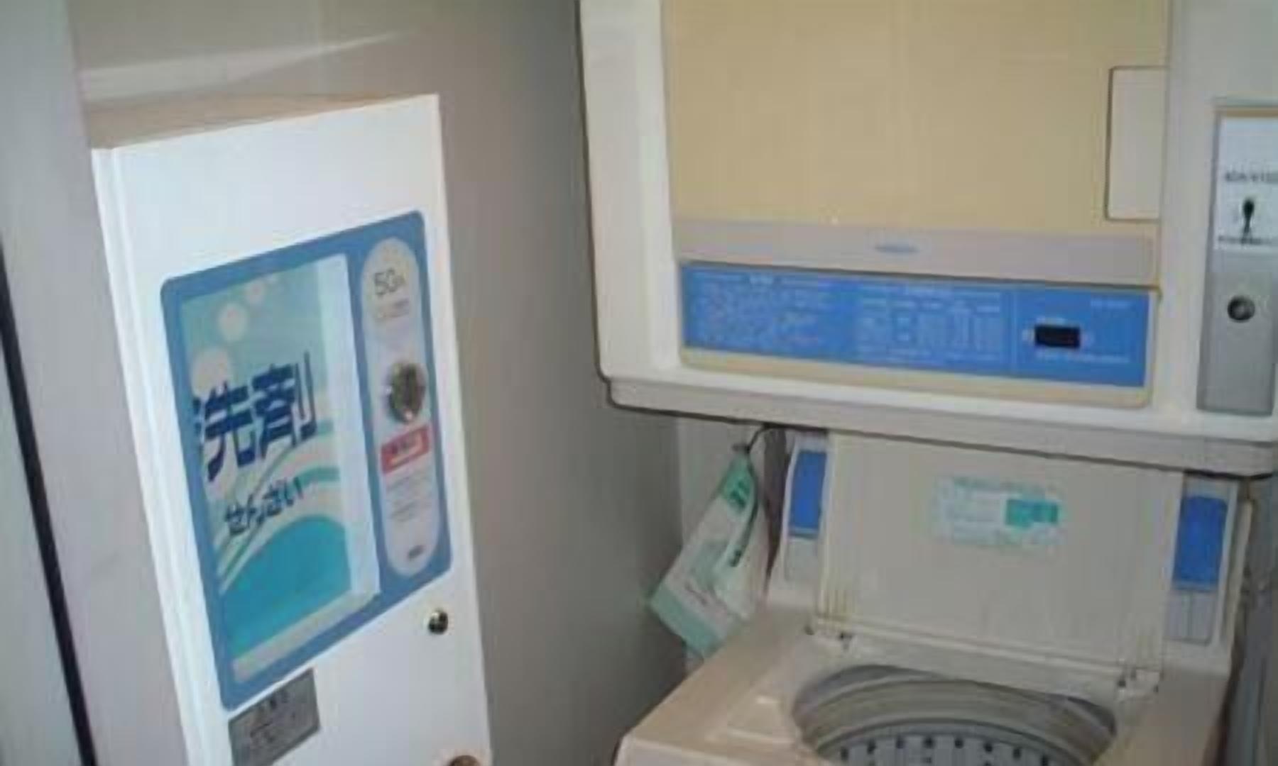 A medical examination room with a toilet, a digital display, and a sign with text.