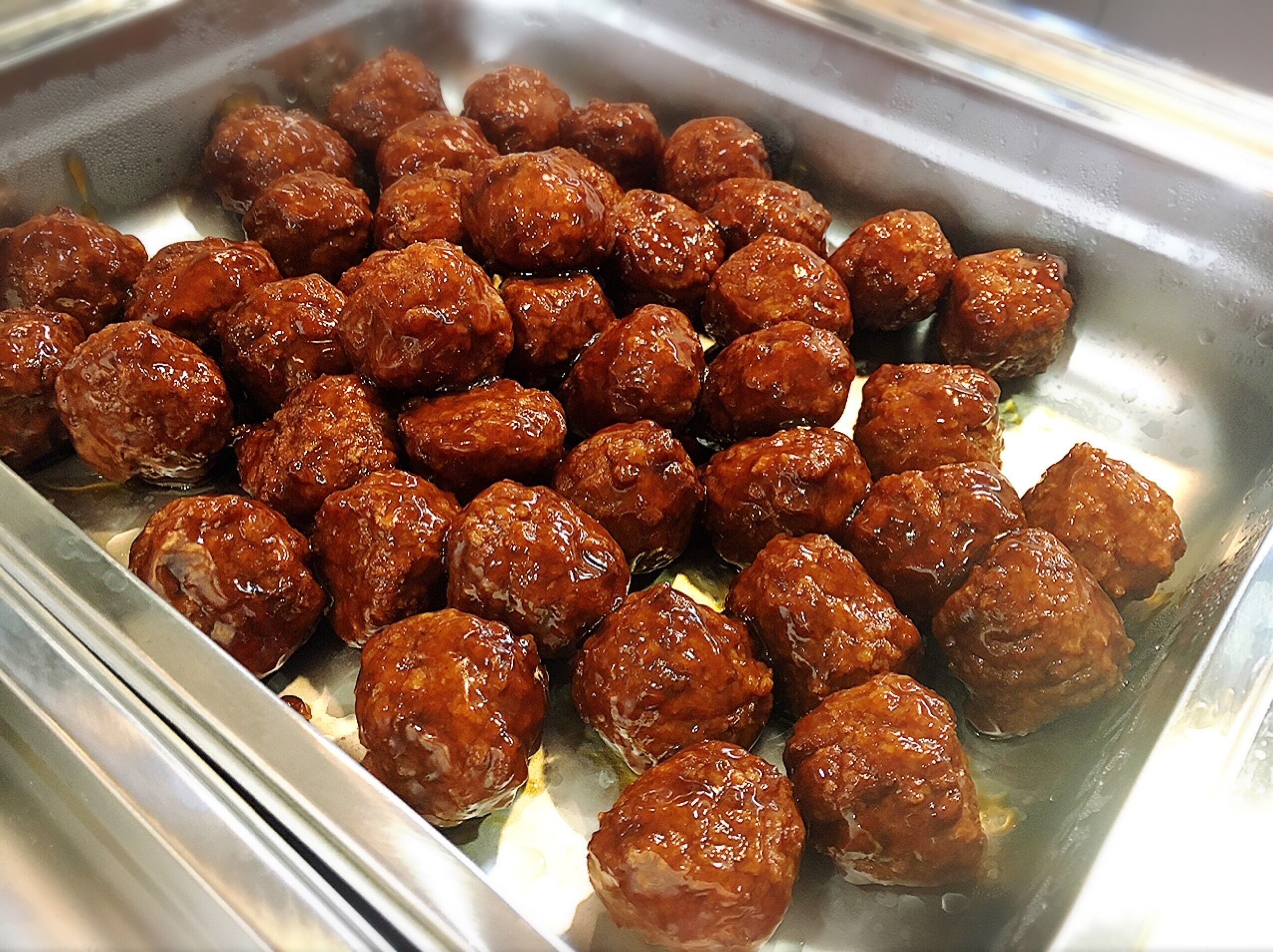 A tray of glazed meatballs.