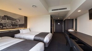 A hotel room with two beds, a desk, and a large painting on the wall. - Plaza Annex (Fujisawa)