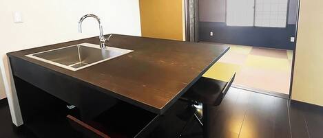A modern kitchen with a built-in sink and a wooden countertop.
