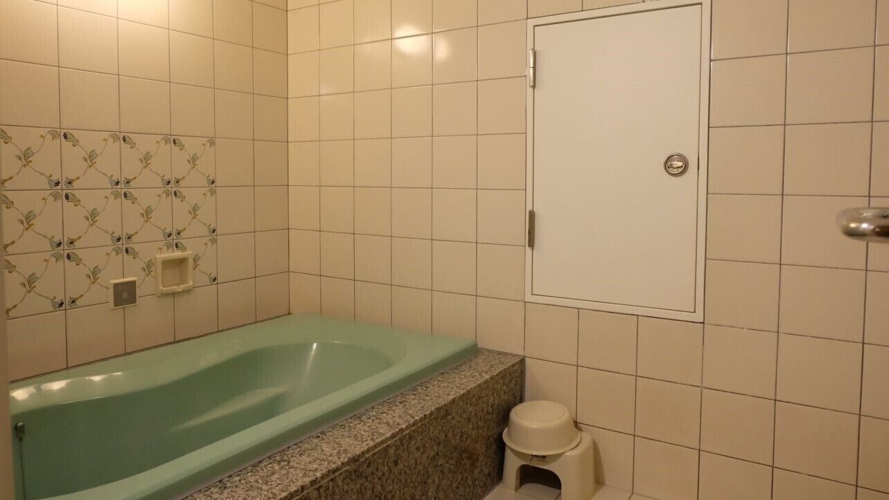 Un baño con bañera, inodoro y zona de ducha.