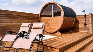 A wooden deck with two sun loungers and a sauna. - Ritomaru Villa @ Hatsuyama iki (Iki)