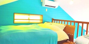 Une chambre à coucher avec un lit, une fenêtre et un appareil de climatisation.