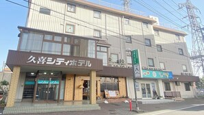 A building with a sign for "HACHI" restaurant and another sign for "HACHI" on the ground floor. - Kuki City Hotel (Kuki)