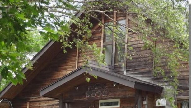 A rustic wooden cabin with a gabled roof, two symmetrical front doors, and a small porch area. - Mountain Inn Marodo (Iiyama)
