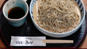 A bowl of noodles with a side of soy sauce and a small bowl of wasabi. - Mountain Inn Marodo (Iiyama)