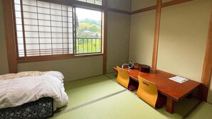 A traditional Japanese room with tatami flooring, a futon bed, a low wooden desk, and a shoji screen window. - Otomaridokoro Nakamura <oki Shoto> (Ama)