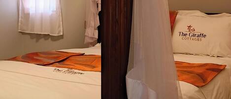 A bed with a canopy, a wooden headboard, a window with sheer curtains, and a pillow with text.