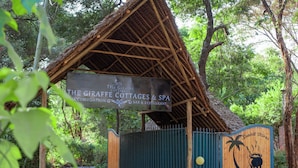 A sign for The Giraffe Cottages & Spa, indicating a restaurant and accommodation. - The giraffes cottages restaurant and bar (Nairobi)
