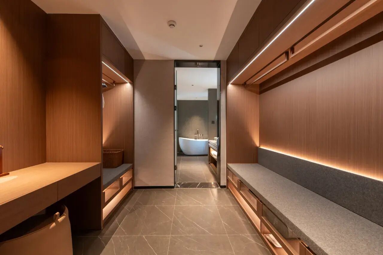 A modern bathroom with a vanity, a bathtub, and a shower area.