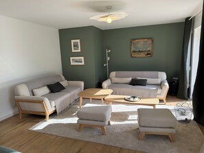 A living room with two sofas, a coffee table, and a small side table. - VILLA ADTHEO (Dinard)