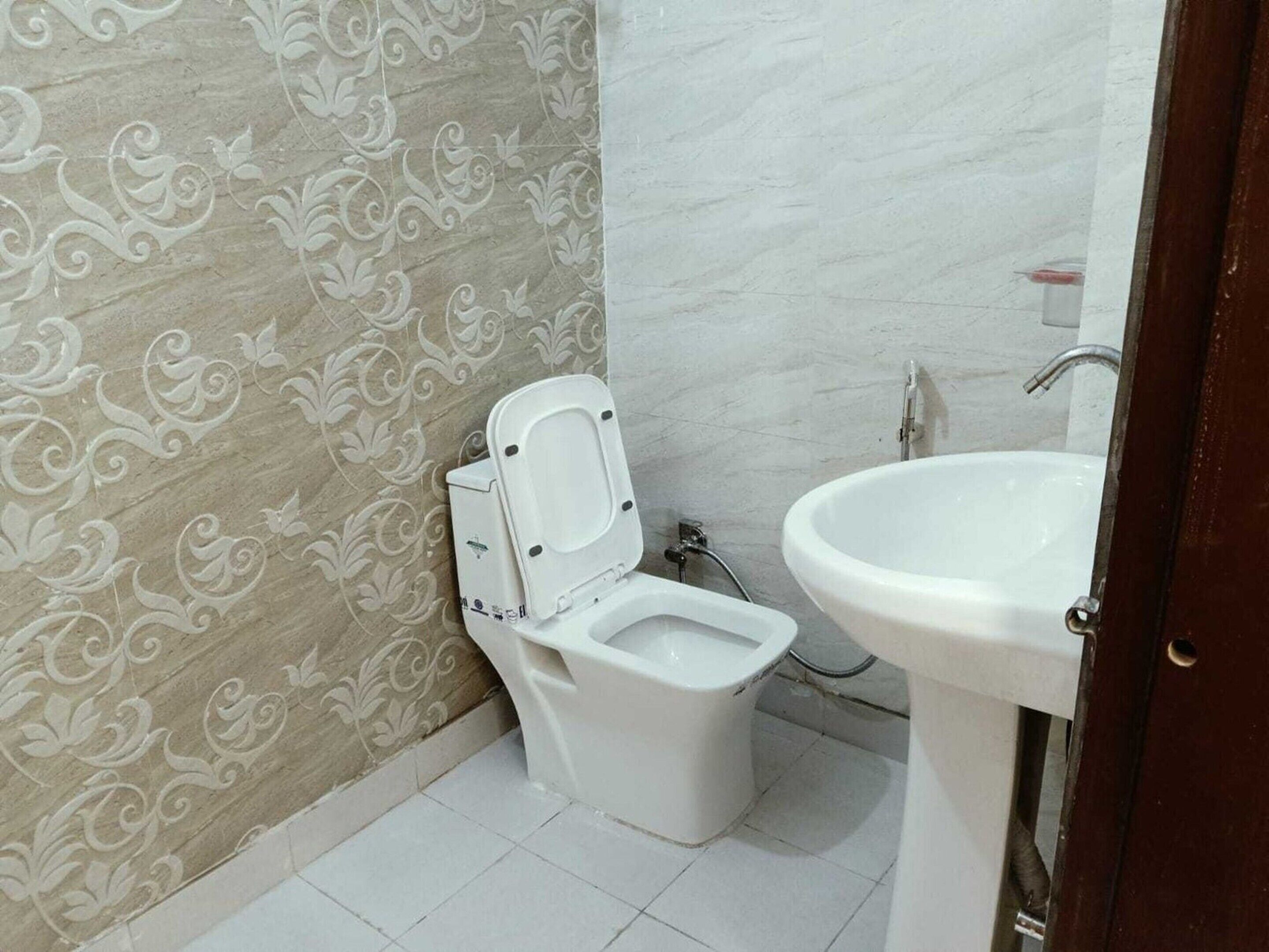 A bathroom with a toilet and a sink.