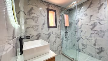 Shower, towels, soap, toilet paper