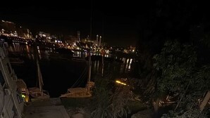 A rooftop terrace with a seating area, a view of the city at night, and a body of water. - BEPY'S NUBAIN HOUSE  (Aswan)