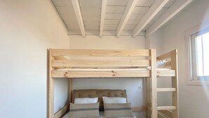 A bunk bed with a wooden ladder, white bedding, and a window on the right. - Casa Lola - Rural apartment with private swimming pool in Cabo de Gata (AN)