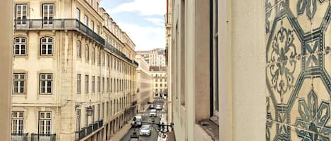 A narrow street lined with historic buildings, a pedestrian crossing, and a bicycle.