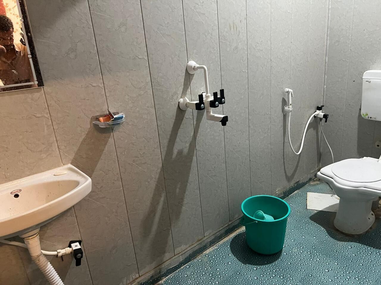 A bathroom with a sink, toilet, and shower.