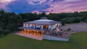 A two-story house with a covered patio and outdoor seating area.