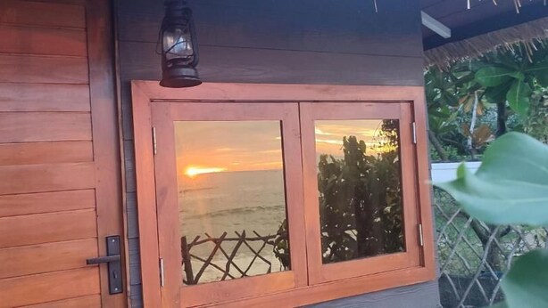 A wooden door with a glass panel and a metal latch.