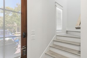 A staircase with a wooden finish, a door with a privacy notice, and a window with blinds. - Spacious 4 Bedroom 4 Bathroom Villa Lago Home – SanDestin Golf and Beach Resort (Miramar Beach)